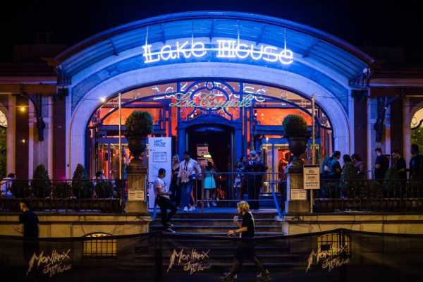 Patrons gather outside the neon-lit entrance of Lake House at night, with the Montreux Jazz Festival logo visible on a banner.