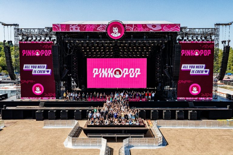 Large outdoor concert stage with bright pink 