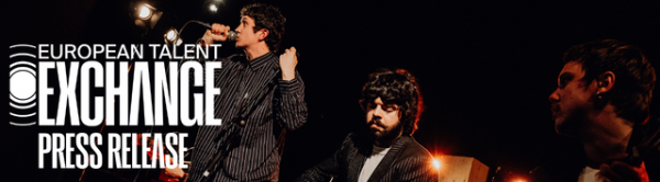 Three men performing music on stage with